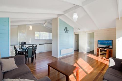 a living room with a couch and a table at Grantys House in Merimbula