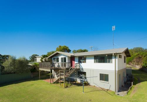 a house with a staircase and a yard at Grantys House in Merimbula
