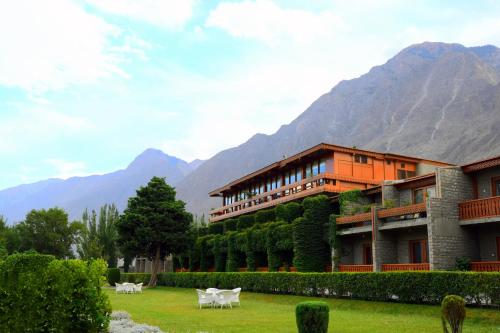 a building with a mountain in the background at Gilgit Serena Hotel in Gilgit