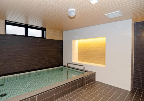 a swimming pool in a building with a pool at Shibetsu Grand Hotel in Shibetsu City