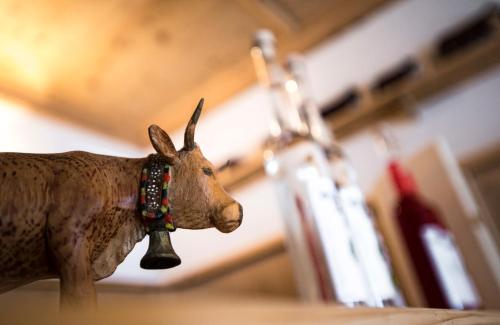 a statue of a cow with a bell on its neck at Leitnerhof in Ramsau im Zillertal