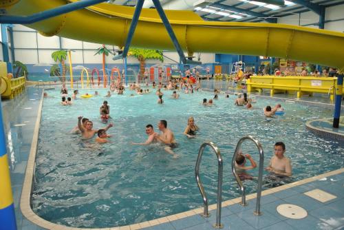a group of people in a swimming pool at 8 berth caravan PG214 Golden Palm Chapel st Leonards in Chapel Saint Leonards