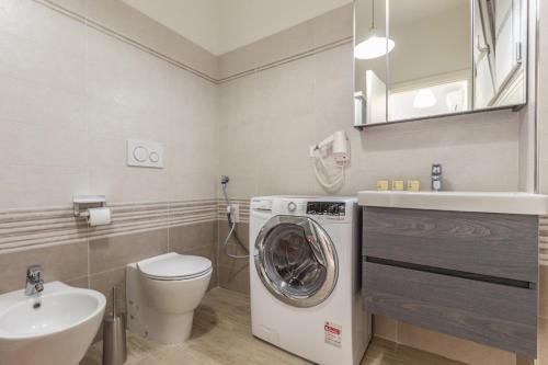 a bathroom with a washing machine and a sink at Martina, Bologna by Short Holidays in Bologna