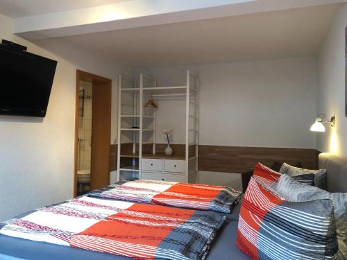 a bedroom with a bed with a colorful blanket at Pension "Tor zum Rennsteig" in Hörschel
