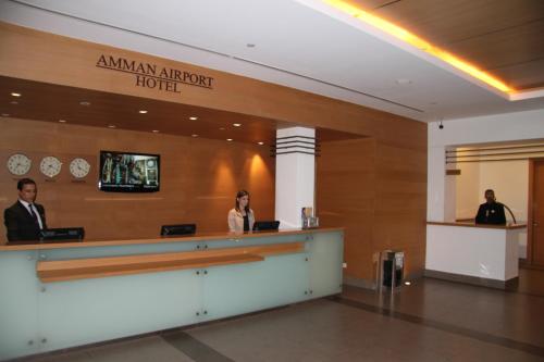 a lobby of an american airport hotel with a reception counter at Amman Airport Hotel in Al Qasţal