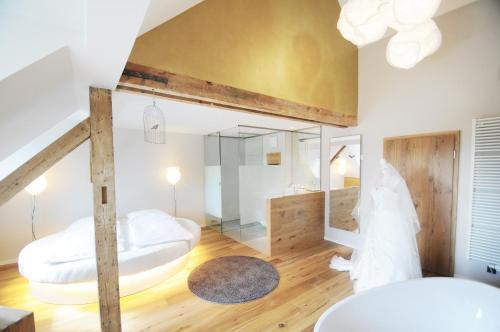a bedroom with two beds and a mirror at Hotel Waldvogel in Leipheim