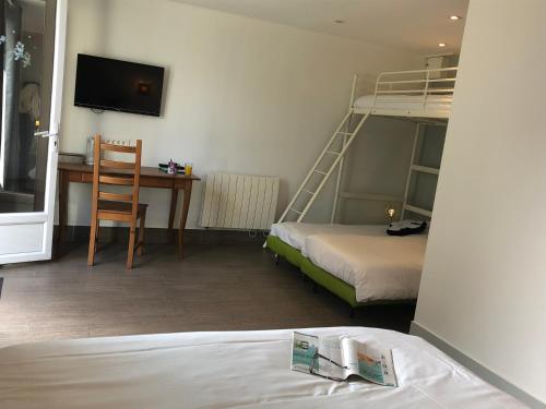 a room with two beds and a desk and a bunk bed at Chambres d'Hôtes Poirier Bazin in Montry