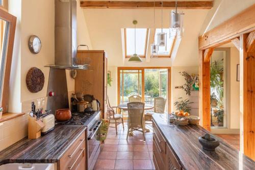 a kitchen with a stove and a dining room at Kenmare Eco Lodge in Kenmare