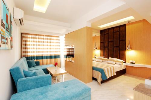 a hotel room with a bed and a couch at Kleopatra Suit Hotel in Alanya