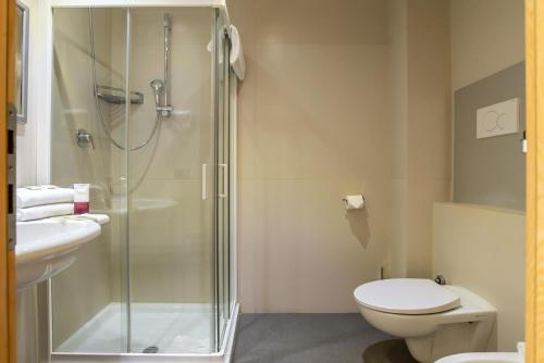 a bathroom with a shower and a toilet and a sink at Hotel Roma Sud in Frascati