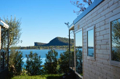 a house with a view of the water at Campeggio Europa Silvella in San Felice del Benaco