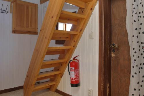 a wooden ladder in a room with a fire extinguisher at Vålågårdens Värdshus och Camping AB in Vålådalen