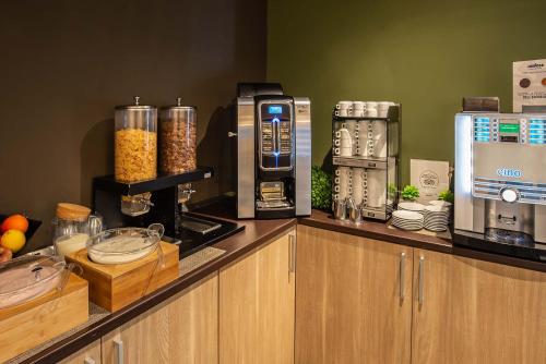 a kitchen with a counter with a coffee maker on it at Hotel Roma Sud in Frascati