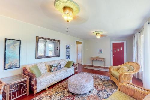 a living room with a couch and a chair at Hamakua Hale Ohana Country Retreat in Papaikou