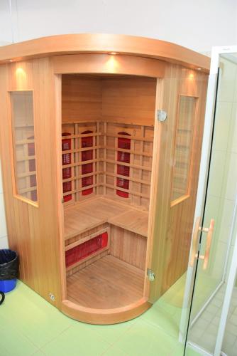 a wooden cabinet with a glass door in a room at Penzion Zátiší in Komorní Lhotka