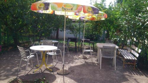 a table and chairs and an umbrella on a patio at Apartments Mira 1804 in Medulin