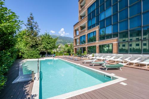 a large swimming pool in front of a large building at Hostellerie Du Cheval Blanc in Aosta
