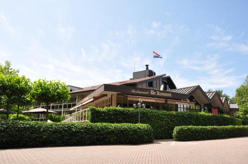 a building with a flag on top of it at Fletcher Hotel Jan van Scorel in Schoorl