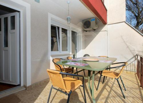a green table and chairs on a balcony at Apartments Mira 1804 in Medulin