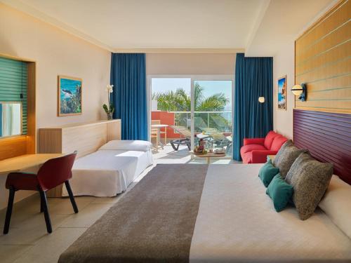 a living room with a bed and a couch at Adrián Hoteles Roca Nivaria in Adeje