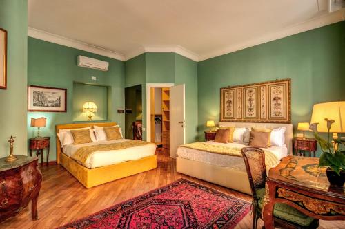 a bedroom with two beds and green walls at Charming Suite by the Vatican sx in Rome