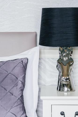 a lamp on a night stand next to a bed at Braid Hills Hotel in Edinburgh