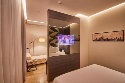 Postel nebo postele na pokoji v ubytování iH Hotels Milano Ambasciatori