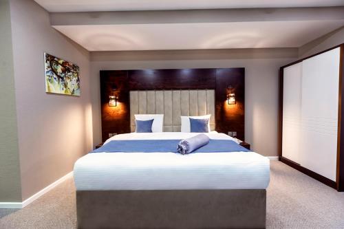 a bedroom with a large bed with blue sheets at Parallel Hotel in Baku