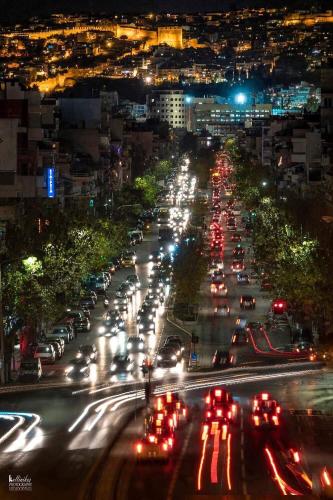 a busy city street at night with cars at Vivian House in Thessaloniki