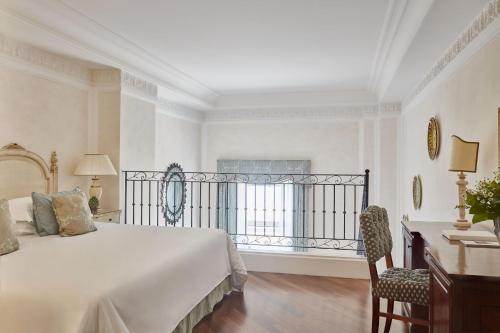 a bedroom with a large bed and a balcony at Grand Hotel Timeo, A Belmond Hotel, Taormina in Taormina
