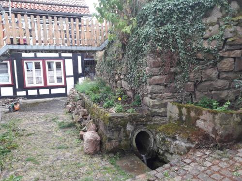 a stone wall with a hole in the side of a building at Fewo Froschkönig in Schieder-Schwalenberg