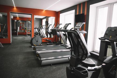 a gym with a row of treadms and machines at Bratislava Hotel Kyiv in Kyiv