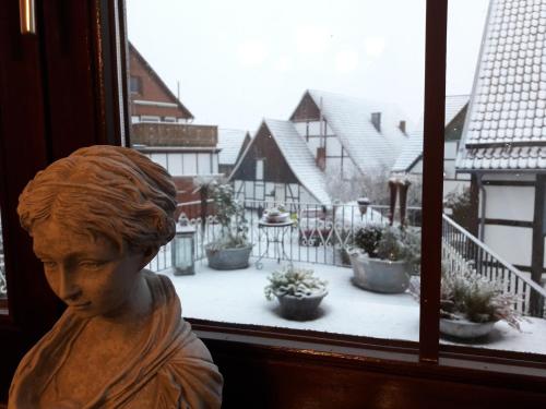 a statue of a woman looking out of a window at Fewo Froschkönig in Schieder-Schwalenberg