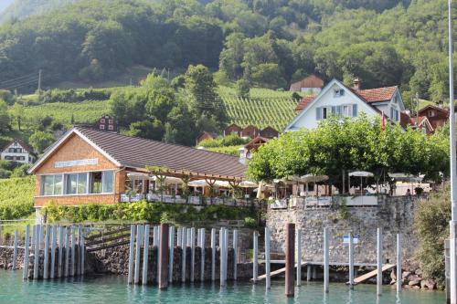 a house on the water next to a lake at Haus Bünten in Quinten