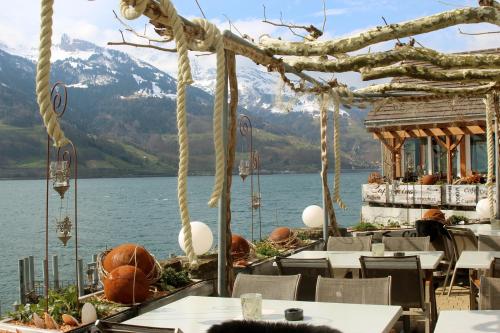 a restaurant with a view of a body of water at Haus Bünten in Quinten