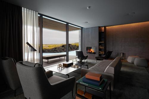 a living room with a couch and chairs and a fireplace at The Retreat at Blue Lagoon Iceland in Grindavík