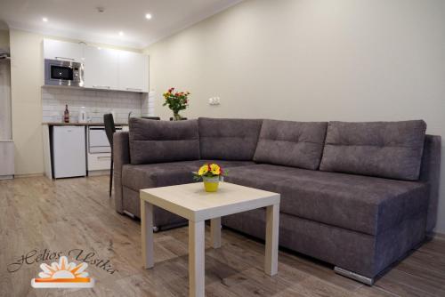 a living room with a couch and a table at Helios Apartamenty in Ustka
