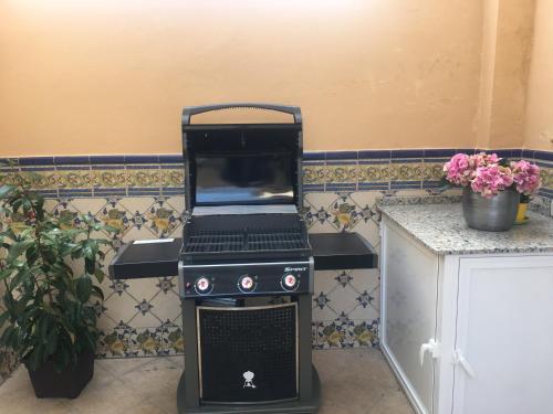 a laptop computer sitting on top of a stove at Apartment with private patio in Fuengirola