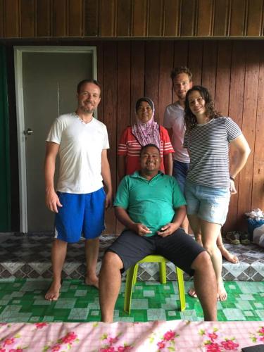 a group of people posing for a picture at Osman’s Homestay in Sukau