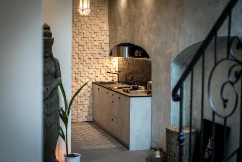 a kitchen with a sink and a stove at Mai Ram Yoga House in Vilnius