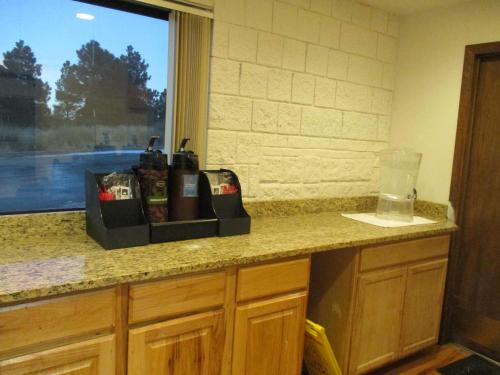 a kitchen with a counter top with a window at Studio 6 Colorado Springs, Colorado - Air Force Academy in Colorado Springs
