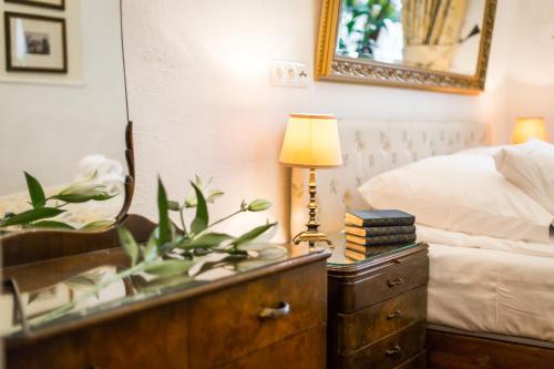 a bedroom with a bed and a dresser with a lamp at VILLA RED by COLUMBUS Ustka in Ustka