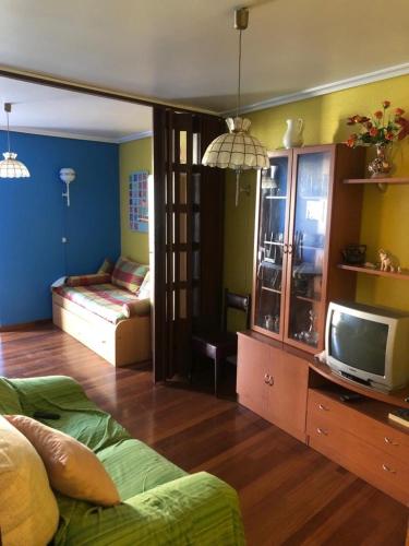 a living room with a bed and a tv at Rías Baixas in Baiona