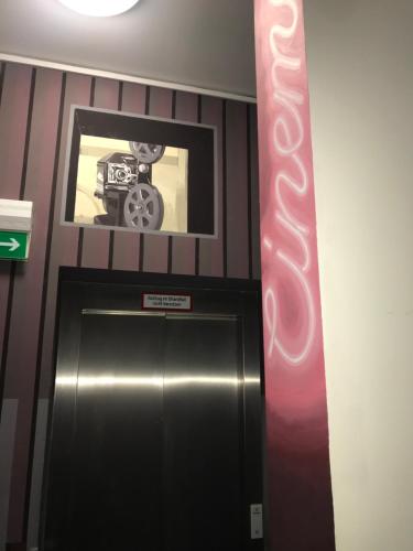 a elevator with a picture of a car above a door at CineHotel Maroni in Zirndorf