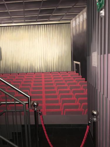 an empty auditorium with red seats in a building at CineHotel Maroni in Zirndorf