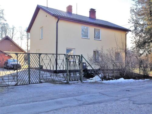 a house with a gate in front of it at Excelent apartment with garden and free parking in Rīga