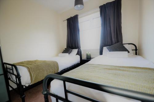 a bedroom with two beds and a window at 14 Castle View Red Lake in Telford