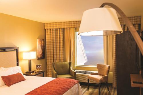 a hotel room with a bed and a window at Amicalola Falls State Park and Lodge in Dawsonville