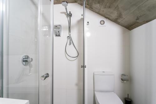 a bathroom with a shower and a toilet at La Puerta de Palacio - Adults Only in Seville