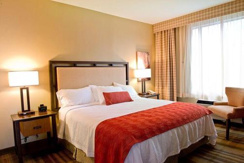 a hotel room with a bed and a chair at Amicalola Falls State Park and Lodge in Dawsonville